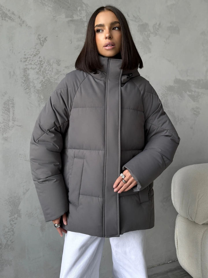 Damen Oversized Steppjacke mit Kapuze und integrierten Taschen