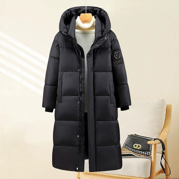 Γυναικείο εξαιρετικά μακρύ καπιτονέ θερμοπαρκά με κουκούλα και ριμπ μανσέτες